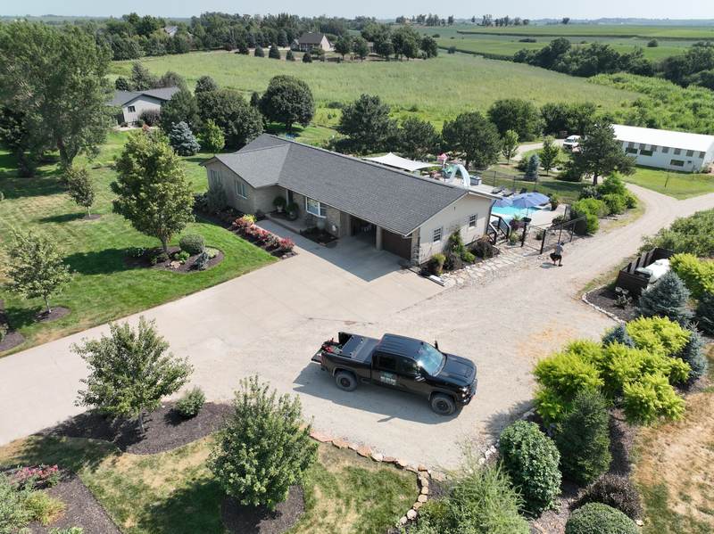 Wide aerial of the finished property with the Mint Exteriors truck in the driveway