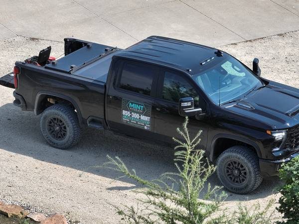 The Mint Exteriors truck parked on a job site driveway
